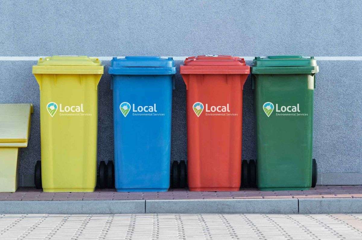 Four colorful garbage bins with the Local Environmental Logo
