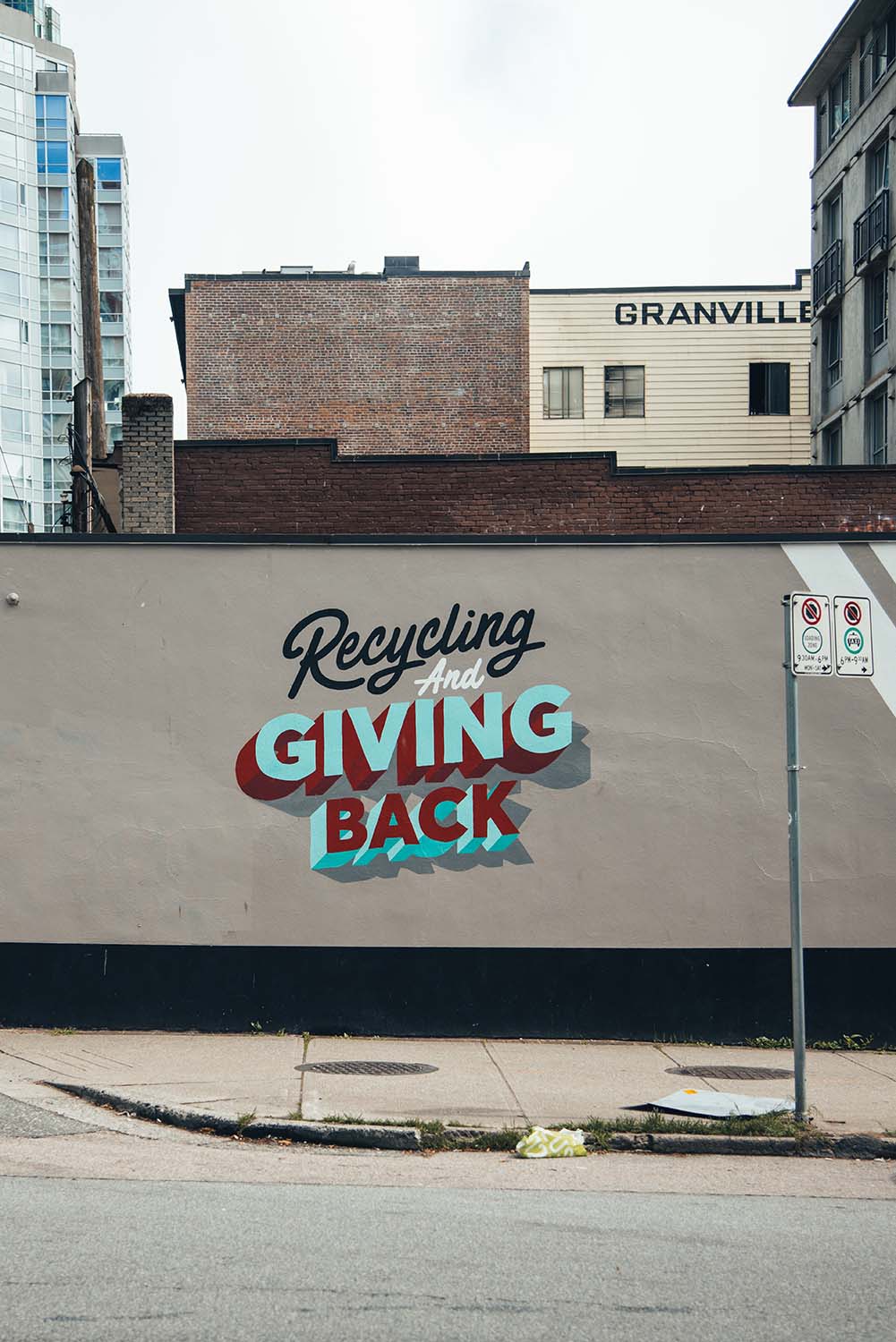 Vancouver street art that reads "Recycling and giving back"