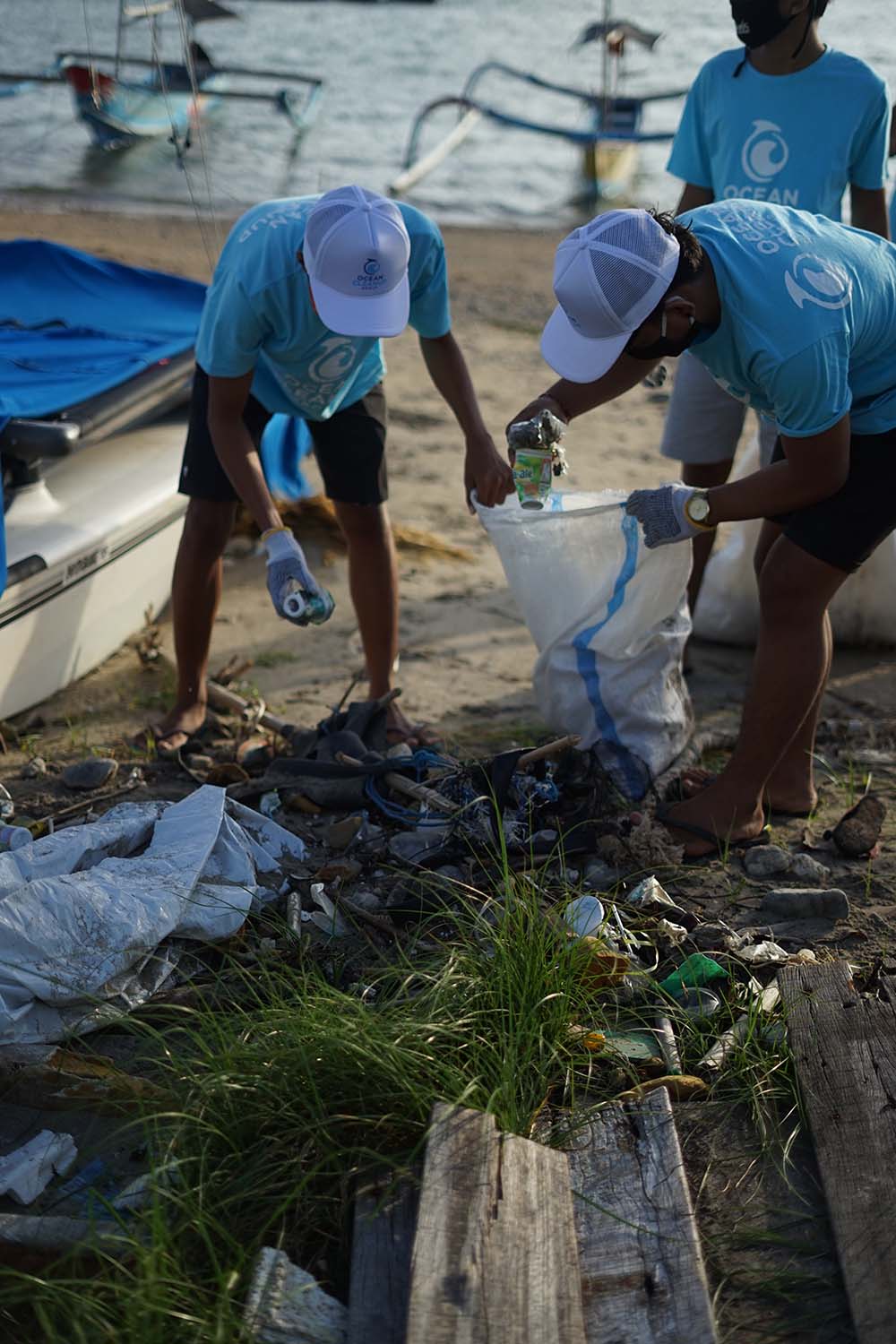 The Ocean Project volunteers cleaning up beach waste.