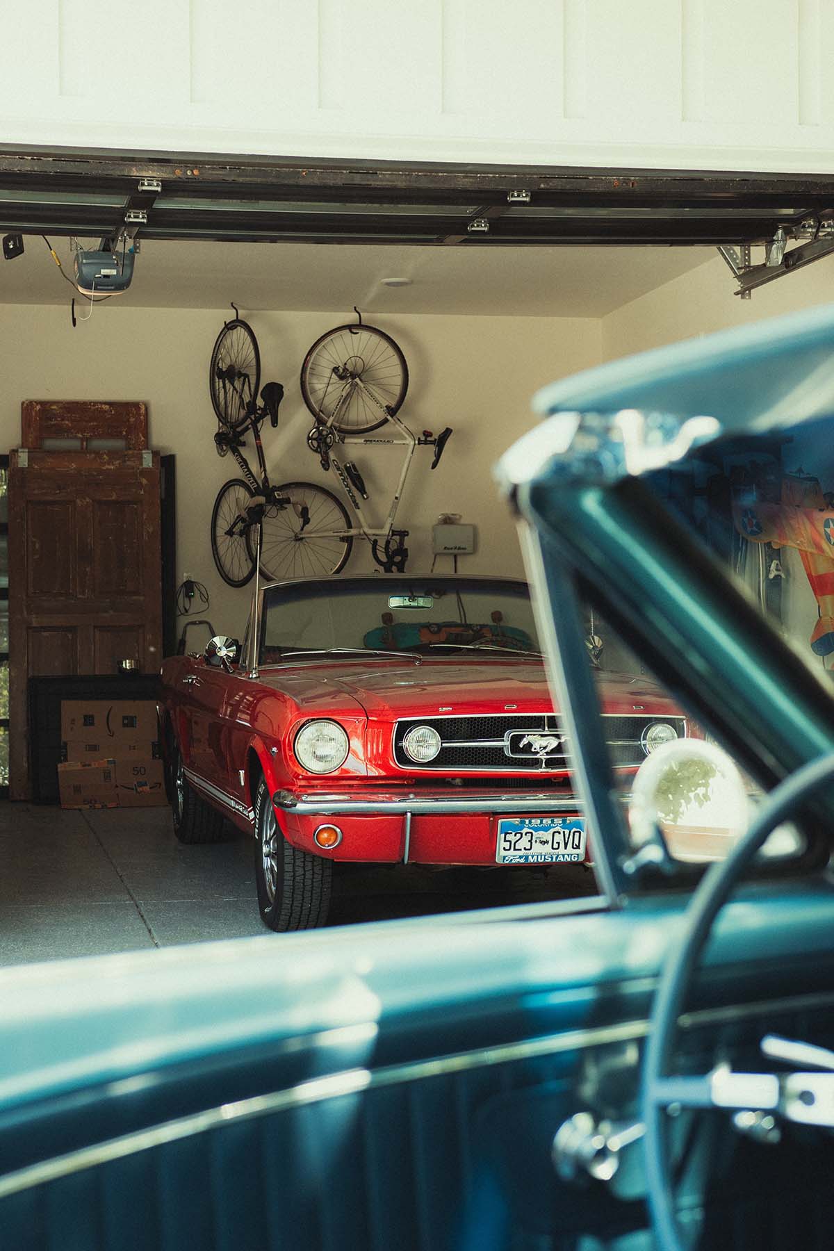 Clean garage with vintage Shelby Mustang parked.
